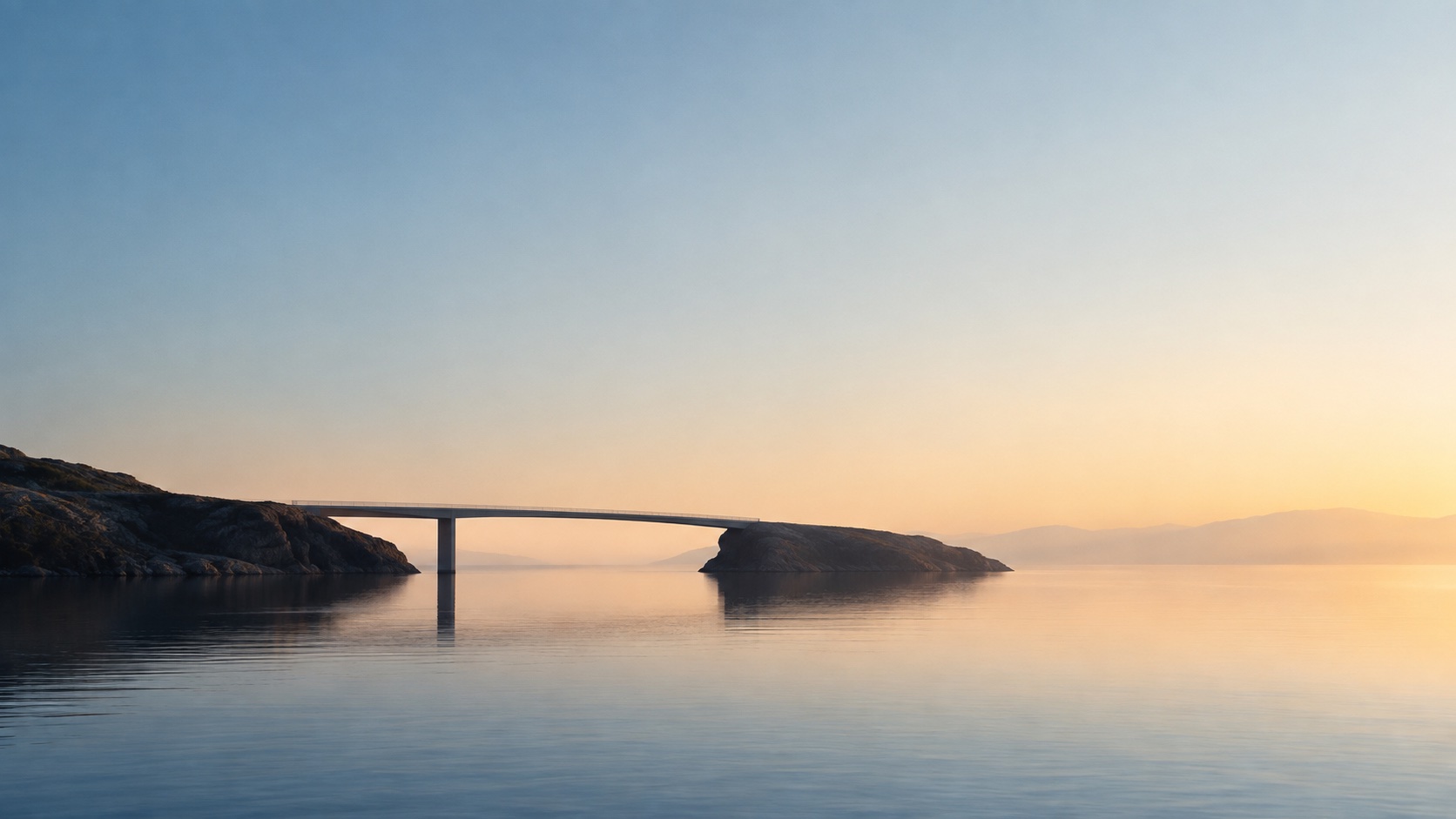 Bridge over calm water at sunrise